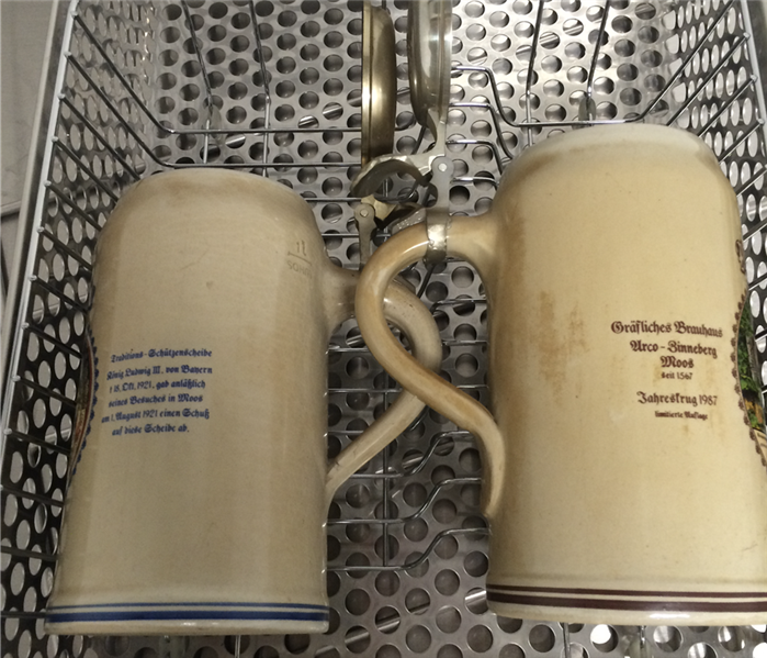 2 mugs in a metal basket covered in smoke 