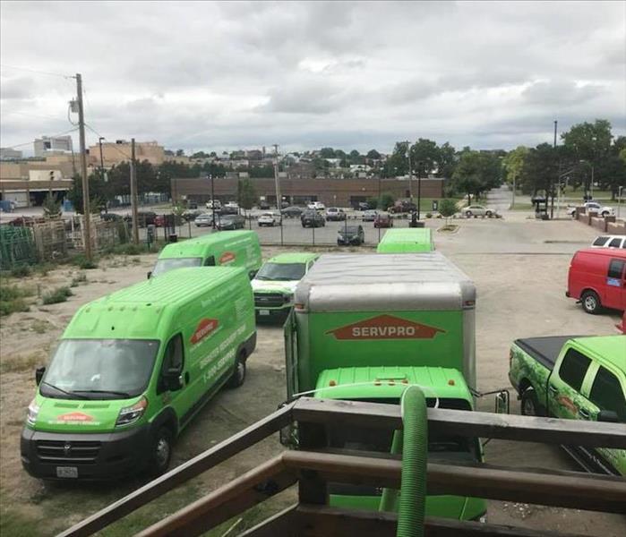 green SERVPRO trucks parked on the street