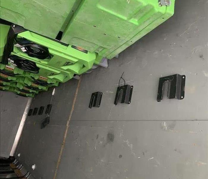 green equipment loaded in a box truck
