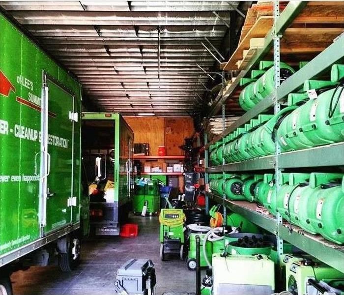 Warehouse with water equipment. Air movers, humidifiers, SERVPRO trucks