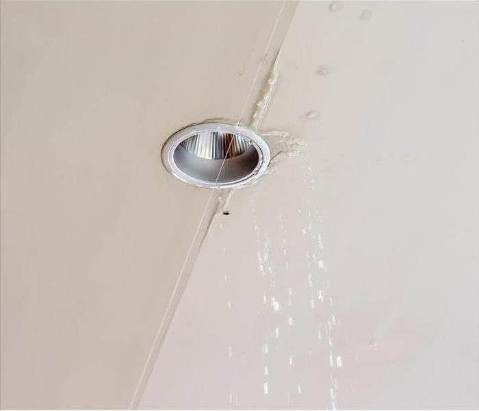Water leaking from ceiling near the lamp